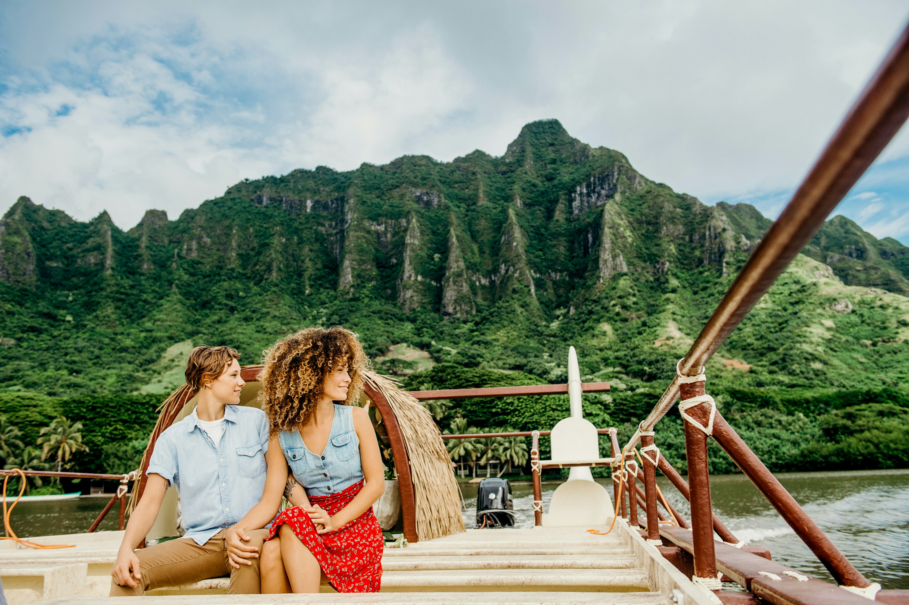 Couple rides boat with Koolau Mountains in the background Windward Oahu  HTA_01616 John Hook HTA RM.jpg